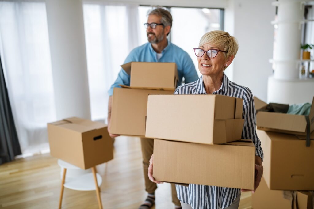 Happy retired senior couple in love moving into a new home, apartment.