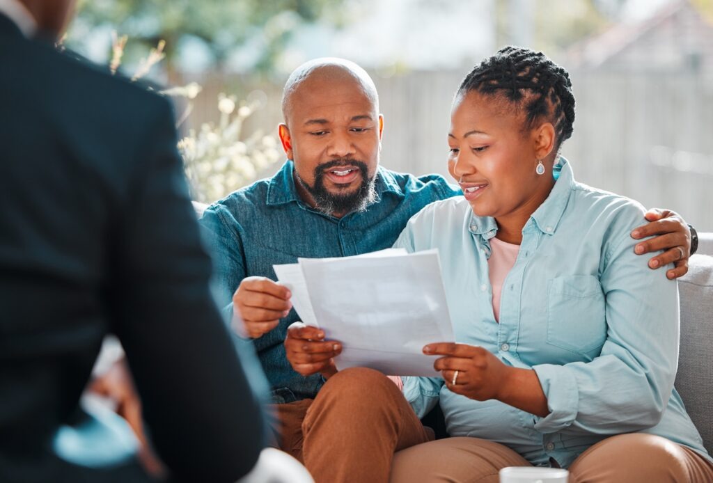 Happy couple, broker and contract in a house for a meeting or consultation for retirement advice. Financial advisor, black man and woman for investment, savings plan or pension and insurance paper.